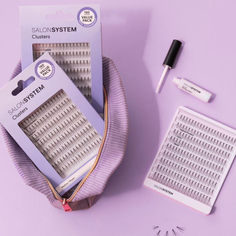 Lash extension supplies on a purple background with a pouch and adhesive.