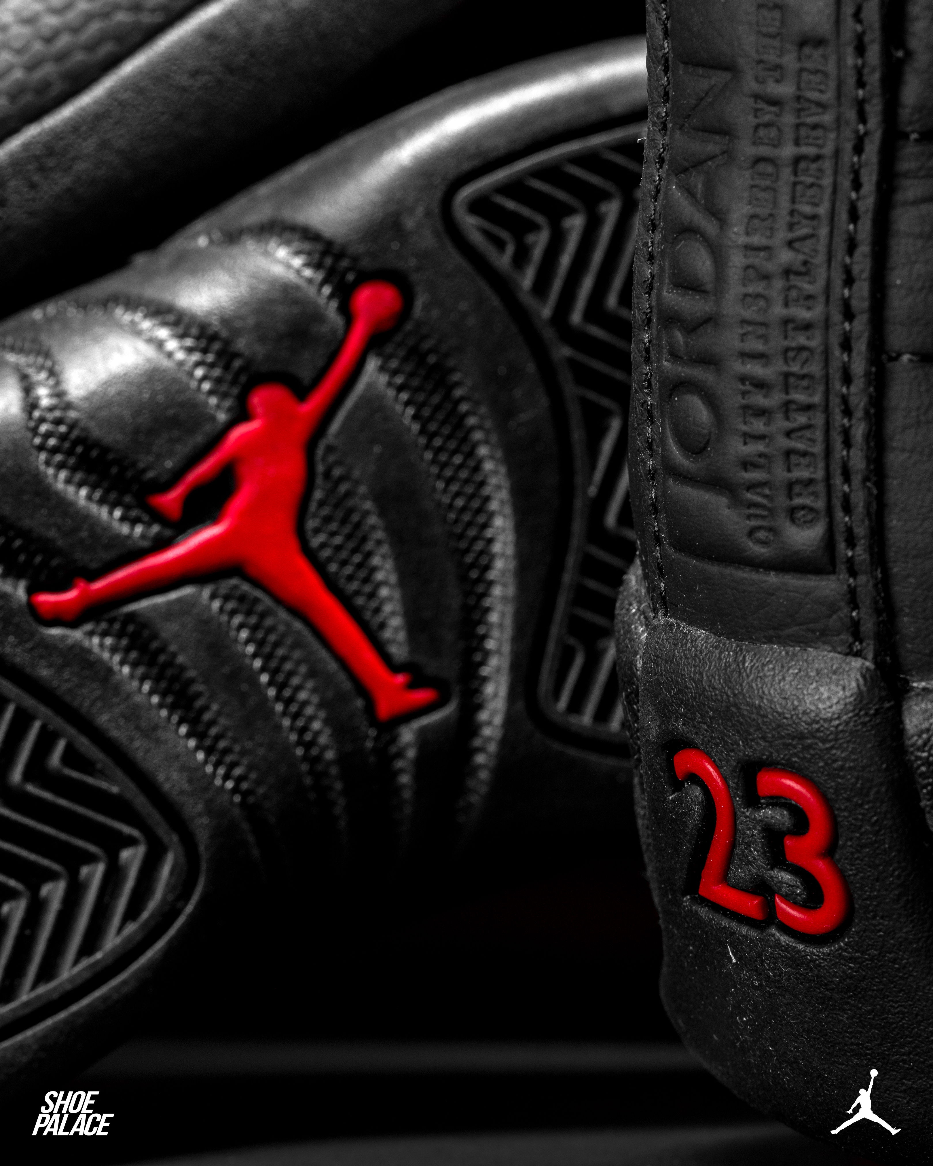 Black sneakers with red Jordan logo and number 23.
