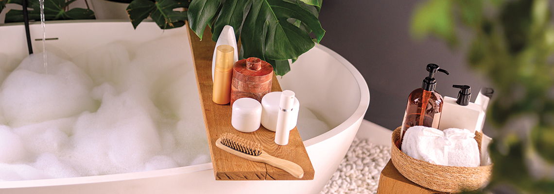 A relaxing bath setup with products and accessories.