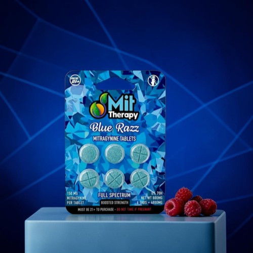 Blue Razz edible therapy tablets on a blue background with raspberries.