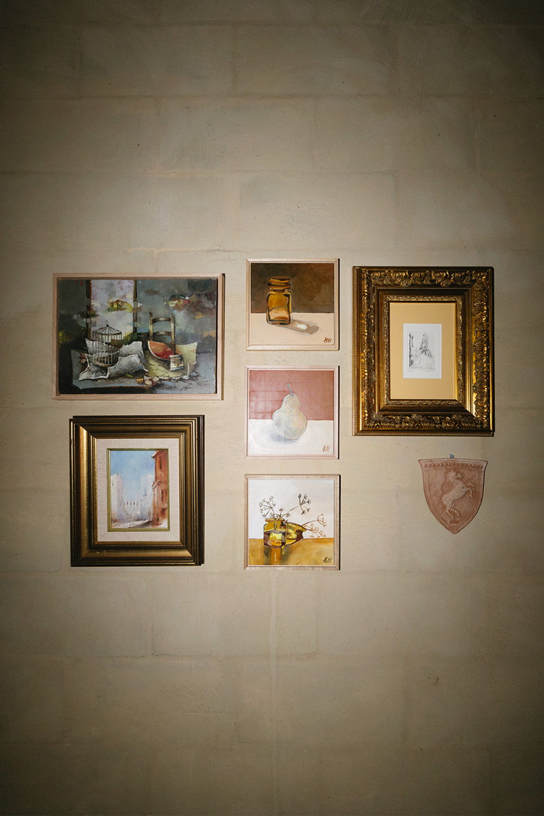 A collection of framed artwork displayed on a wall.