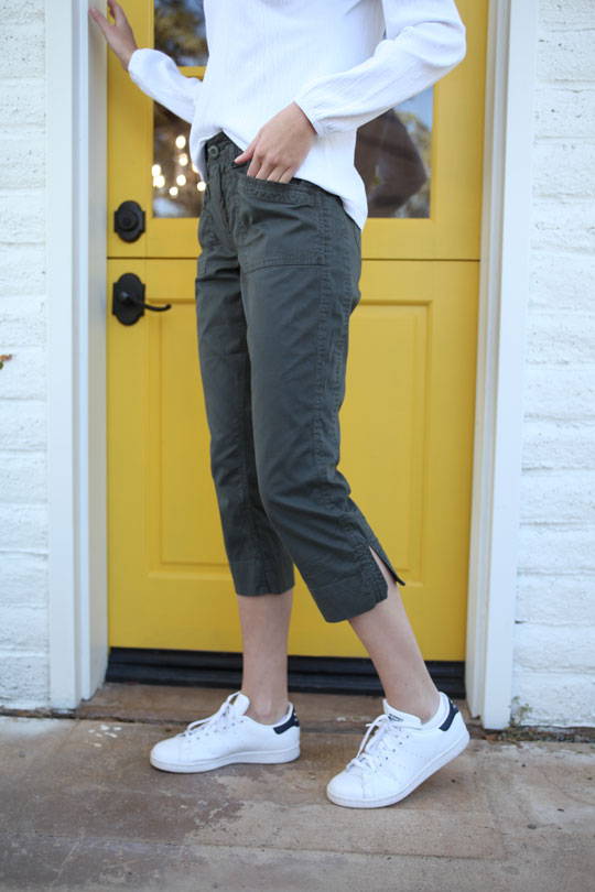 woman standing outside wearing dark green Arden Crop Pant.