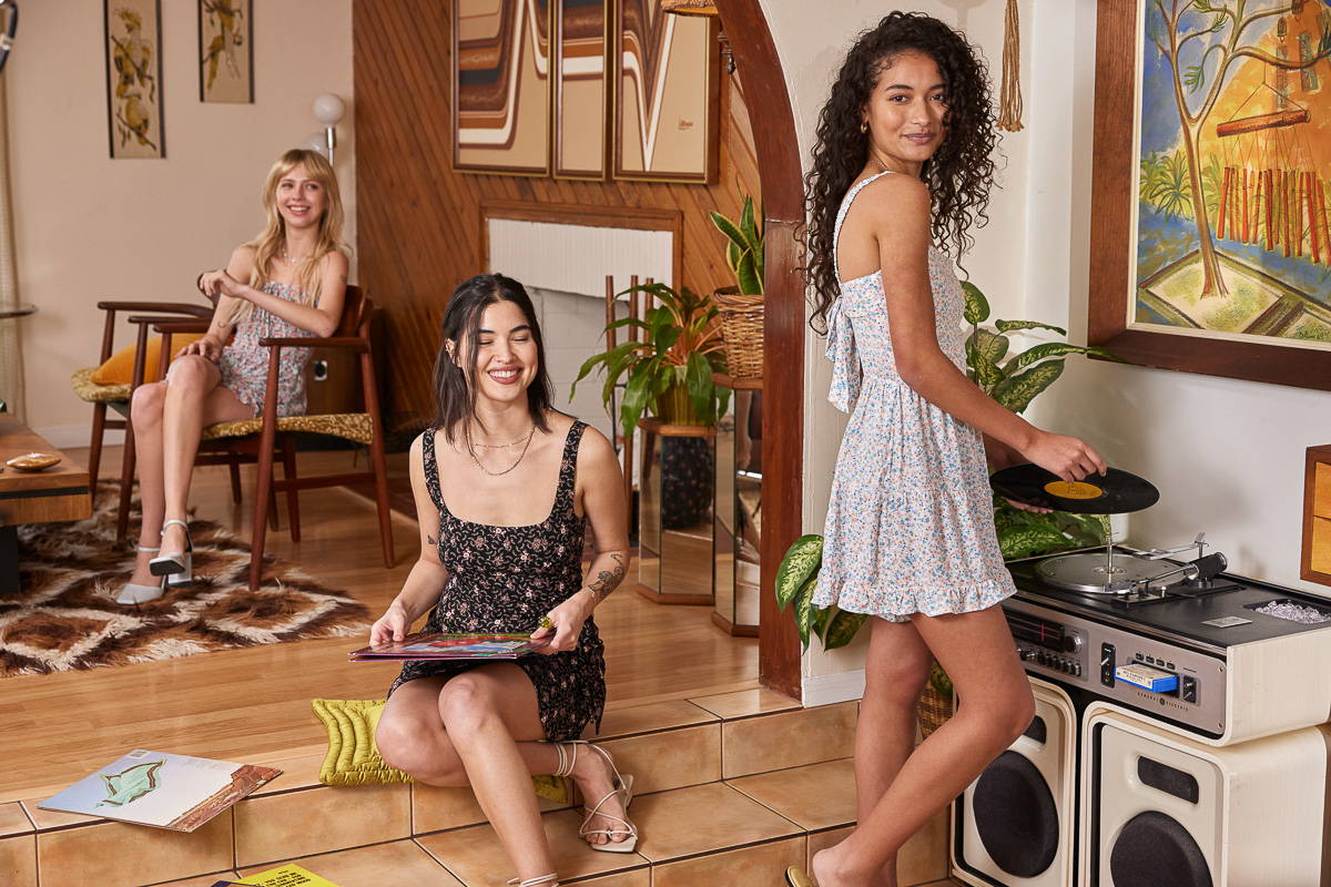 Trixxi Spring Summer girls playing records hang out in floral printed dresses and rompers.