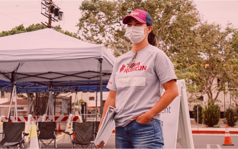 Woman wearing a face mask and holding a dossier