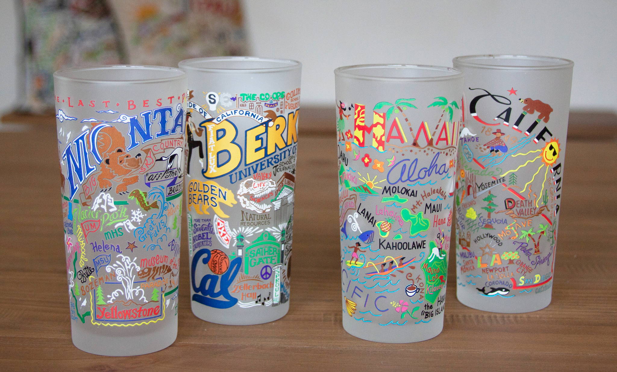 Montana, Cal Berkeley, Hawaii, and California drinking glasses on table