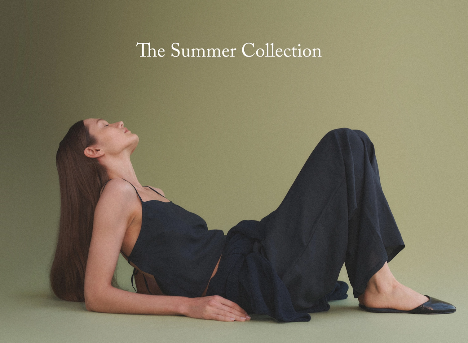 text: The Summer Collection. Woman laying on back propped up on elbows