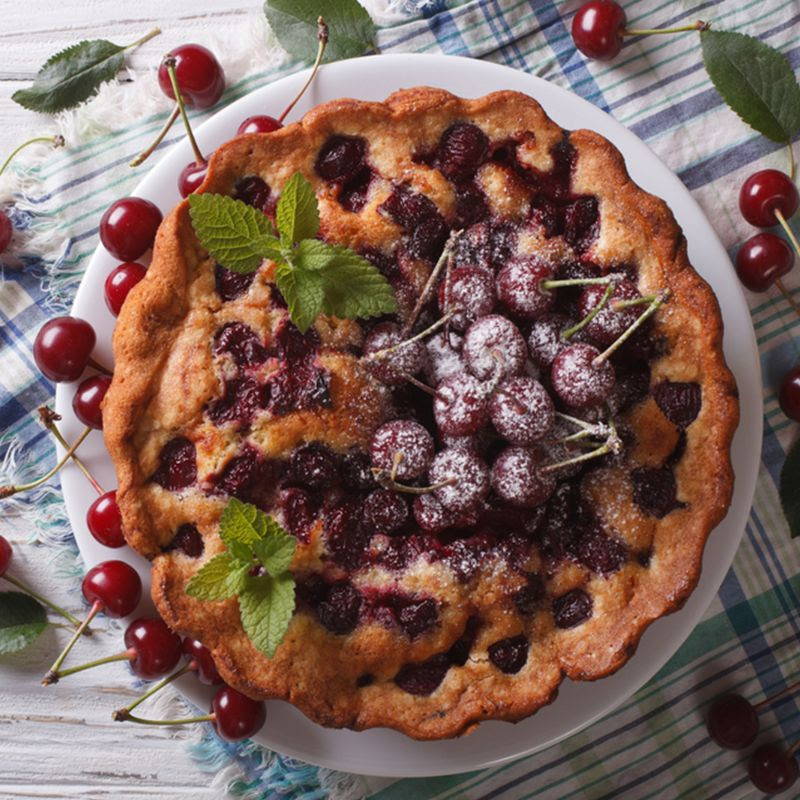 cherry pie with whole cherries on top with sugar