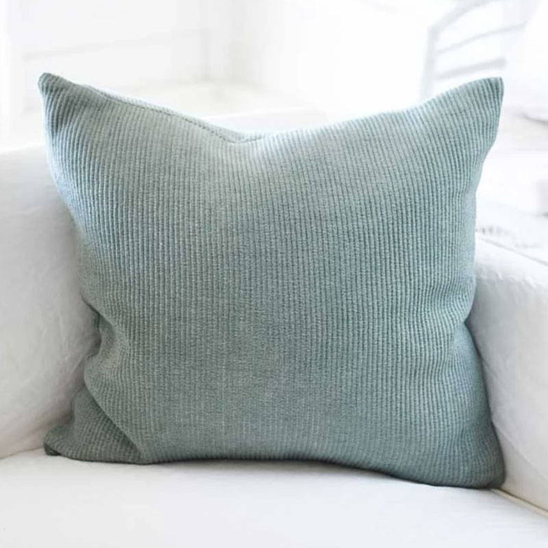 Green Velvet Ribbed Cushion on white sofa