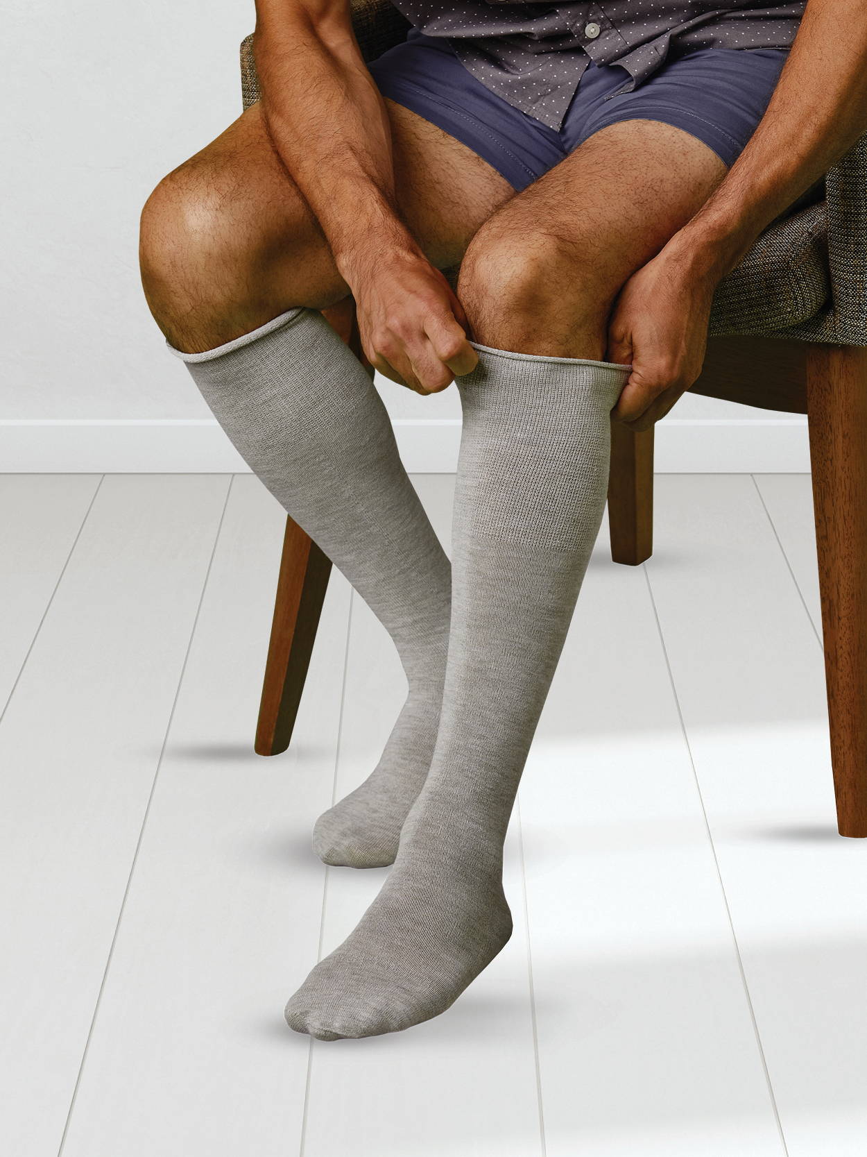 Man sitting in chair putting on SmartKnit AFO sock