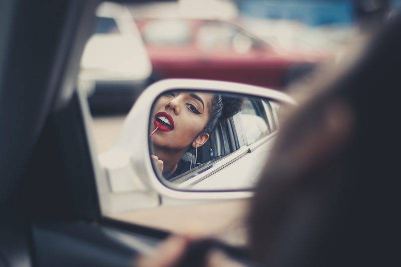 Woman Doing Makeup In Car