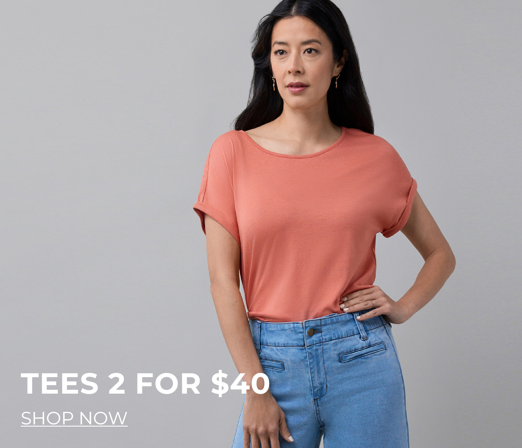 Model wearing a coral t-shirt and blue jeans, promoting a sale.