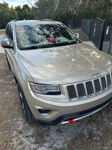 Front three-quarter champagne 2014 Jeep Grand Cherokee WK2 chrome grille seven-slot Jorn's Shocker XL train horns featured customer install gallery photo 1