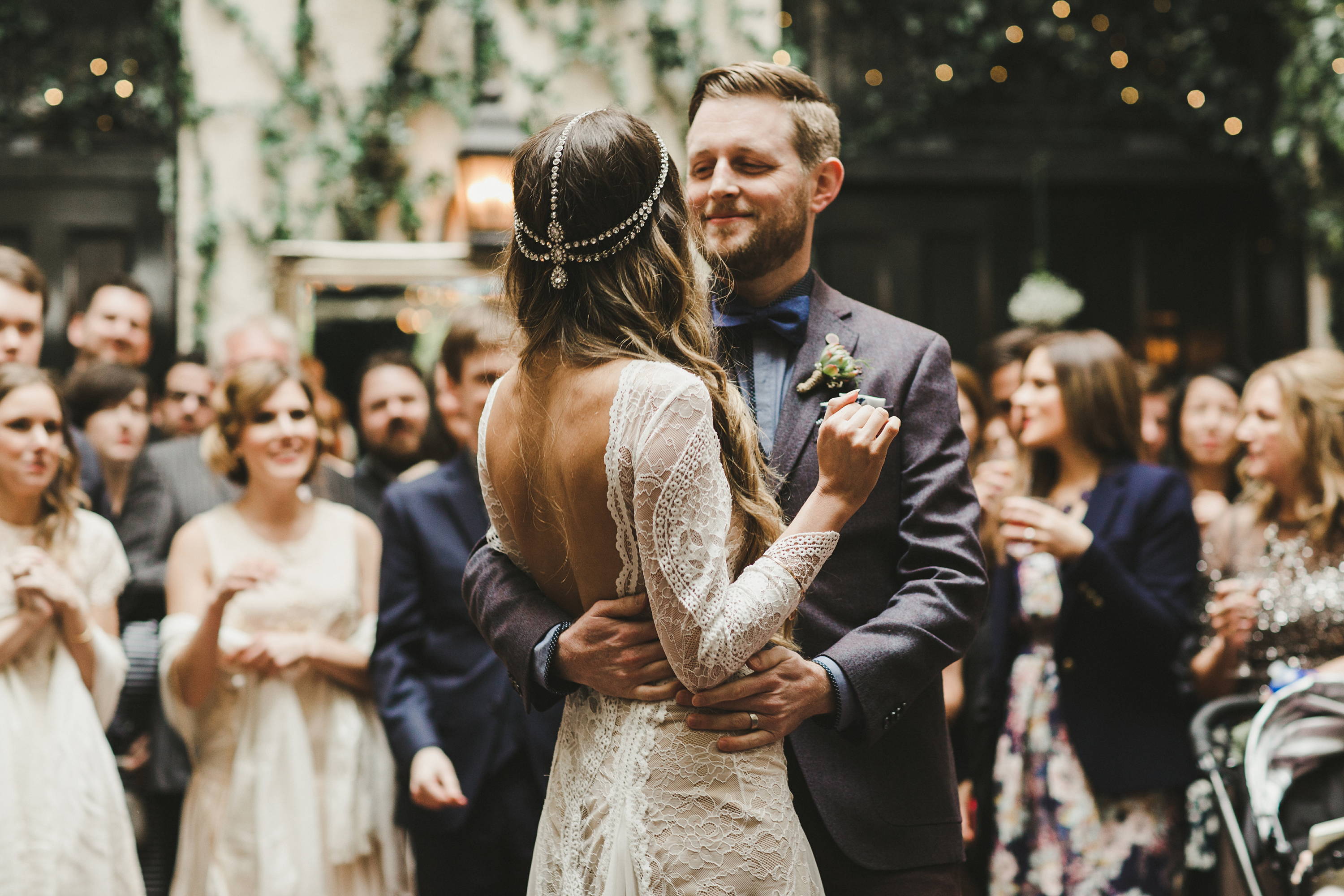 Bride with headpiece and groom in grey suit