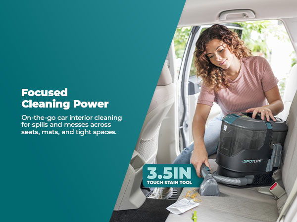 Woman using a vacuum cleaner in a car interior.