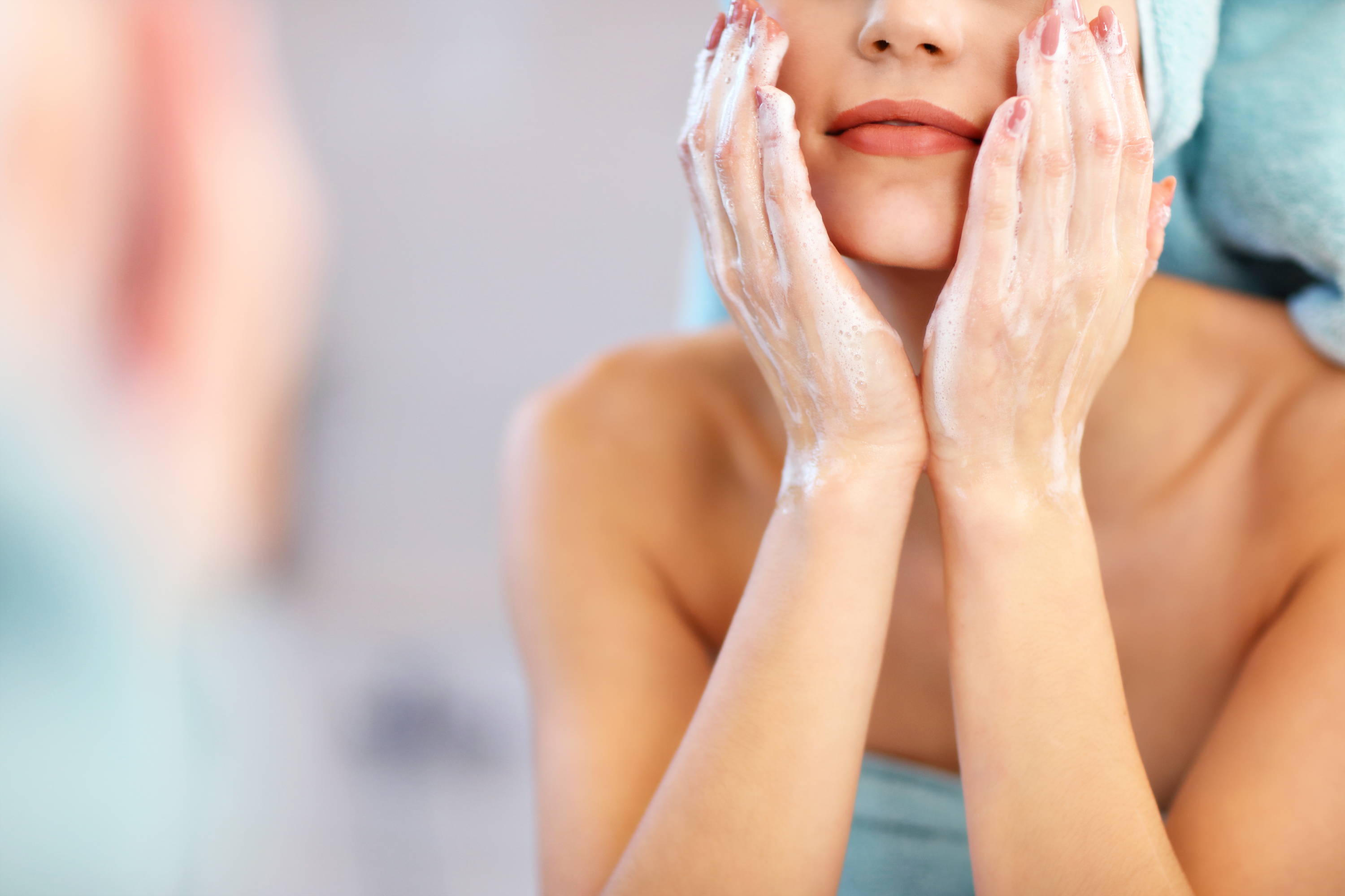 La imagen de una mujer lavándose la cara