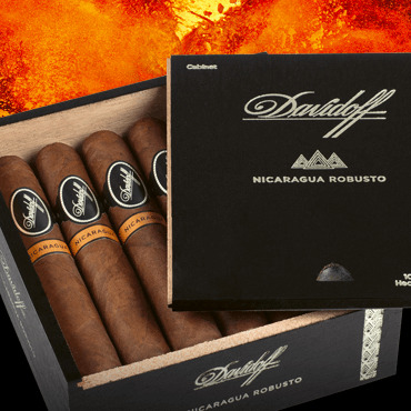 Davidoff Nicaragua cigars in their box with the lid open. Fire in the background.