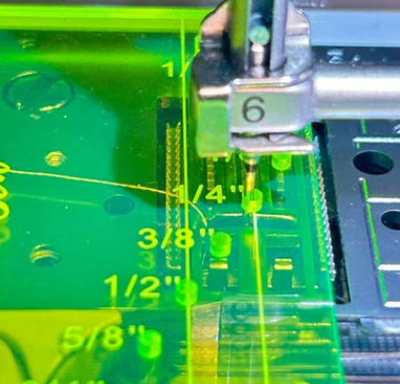 Close-Up Of The Needle In The ¼-inch Hole Of The Seam Guide Ruler