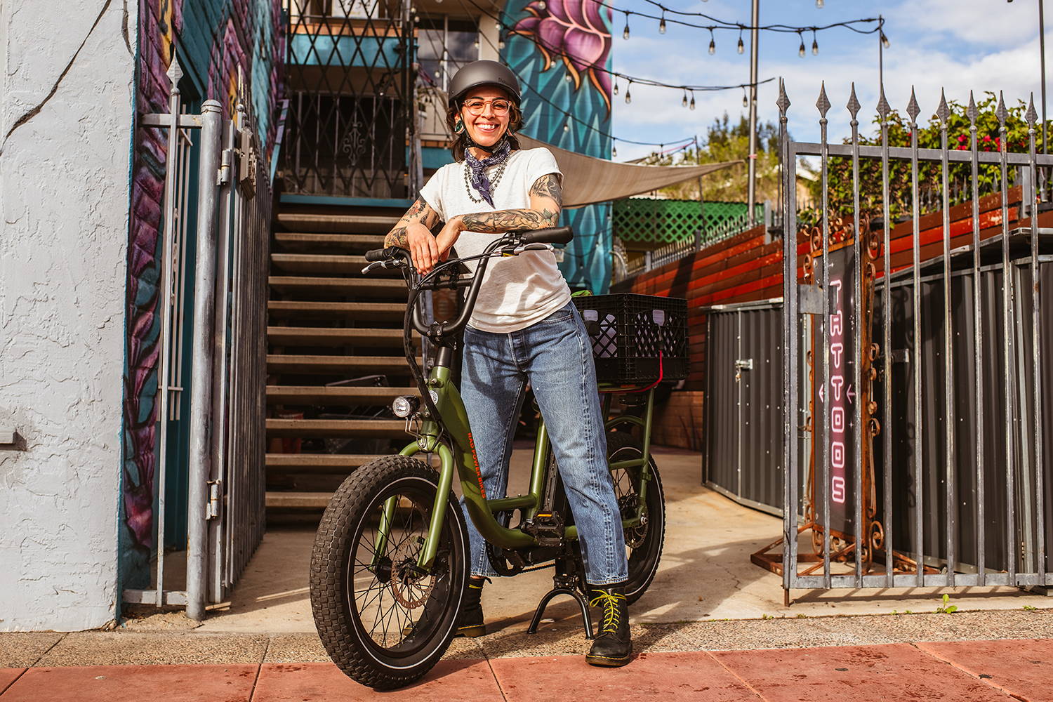 Woman on a RadRunner electric utility bike smiling and wearing a helmet