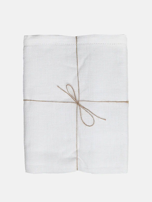 A neatly wrapped white cloth tied with a natural twine bow.