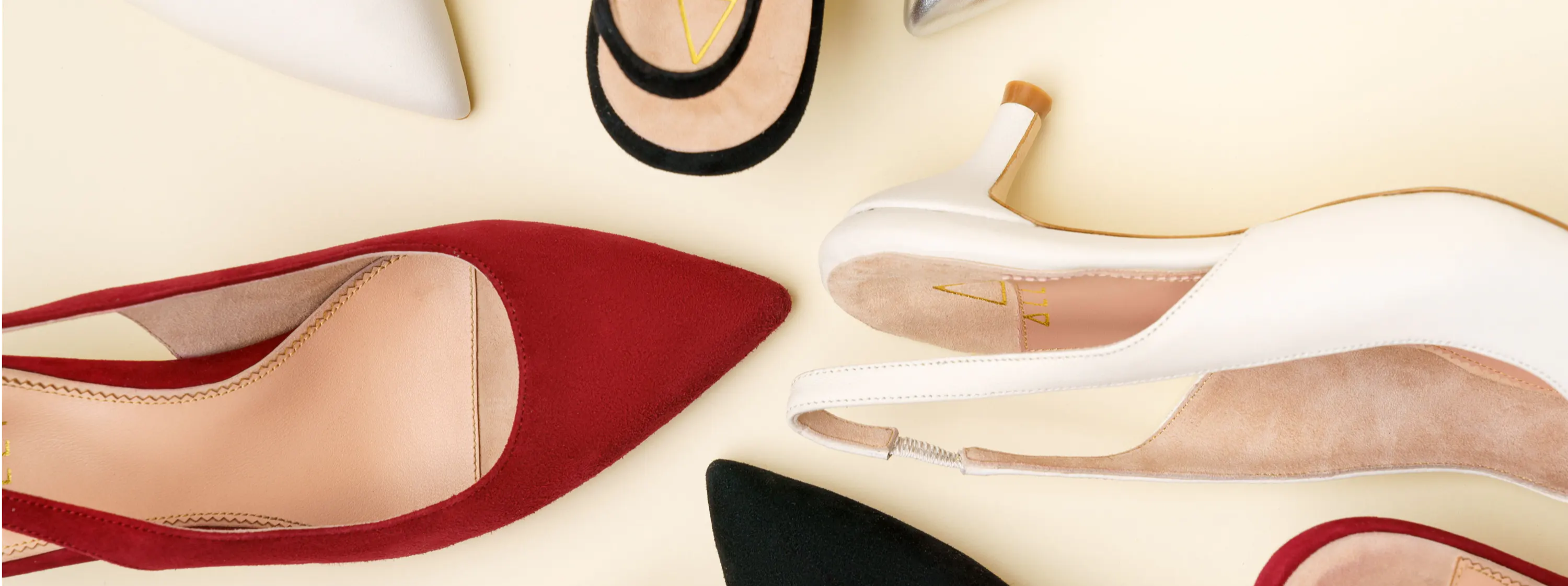 A variety of high-heeled shoes in different colors arranged in a circle.