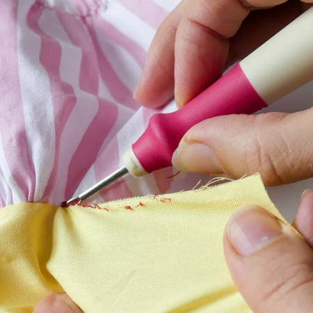 Using a seam ripper to take seam out between two blocks