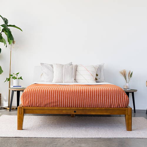 Terracotta SoftWool Blanket on bed