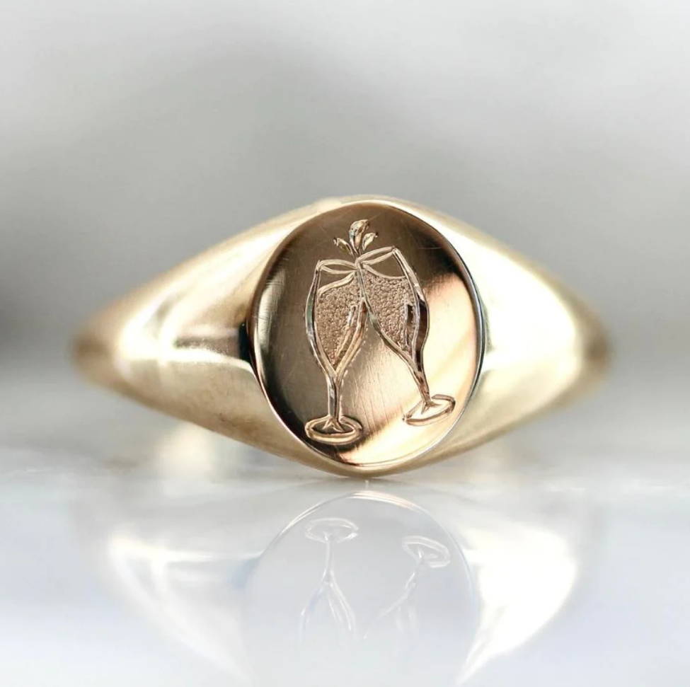 signet ring with engraved champagne glasses