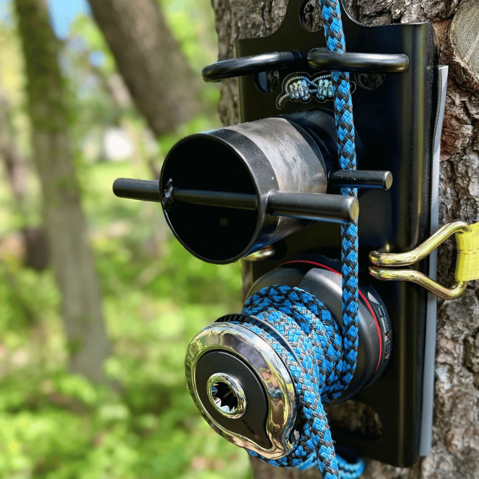 Camera mounted on a tree with colorful rope and hardware.