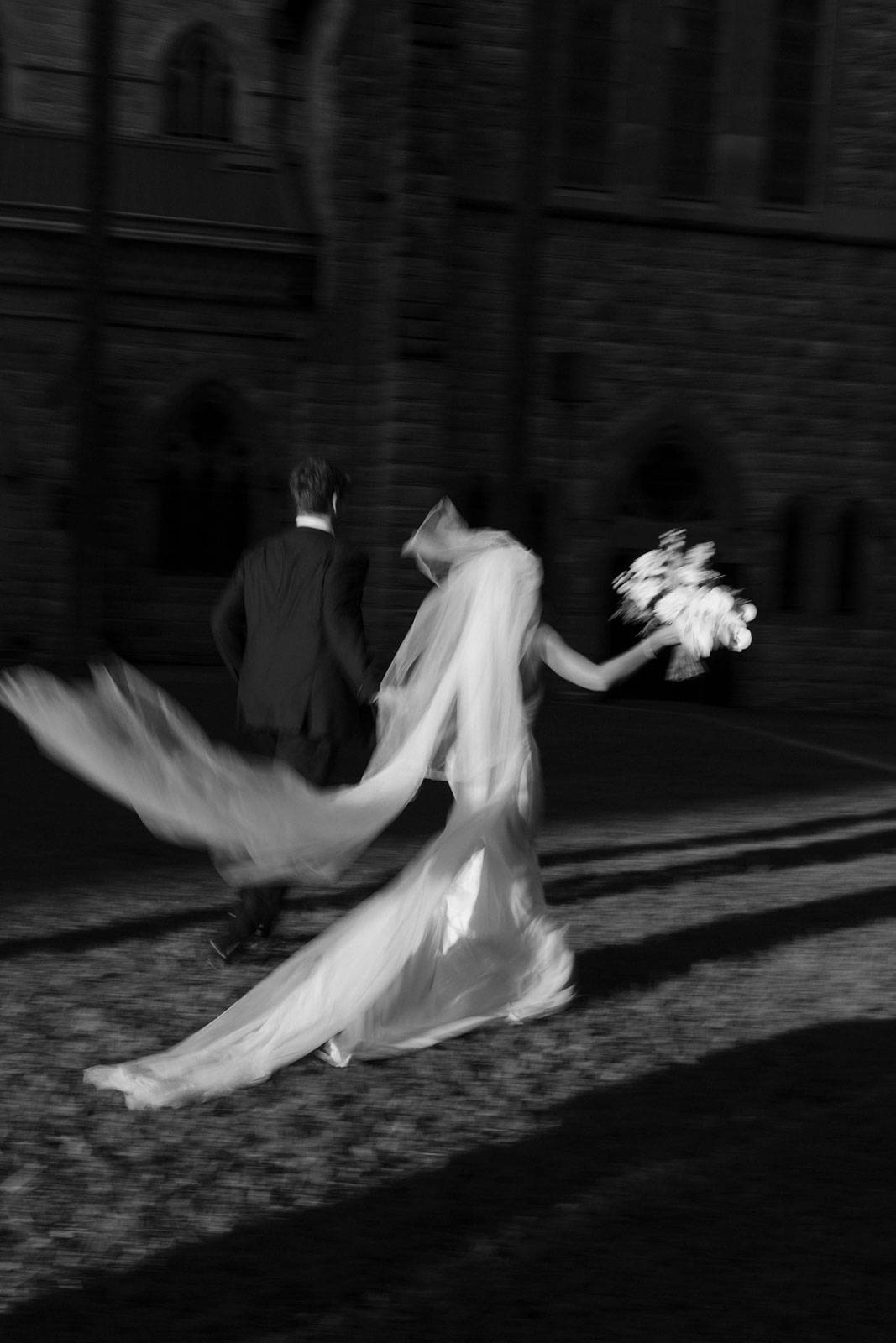 Bride and Groom running black and white