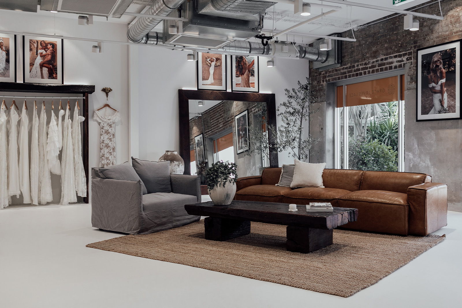 Modern living room with a brown sofa, gray chair, and decorative artwork.