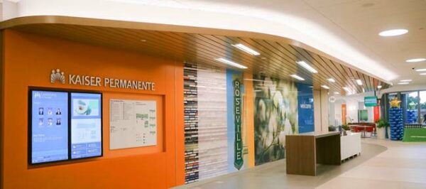 Interior of a modern building with information displays and colorful wall art.