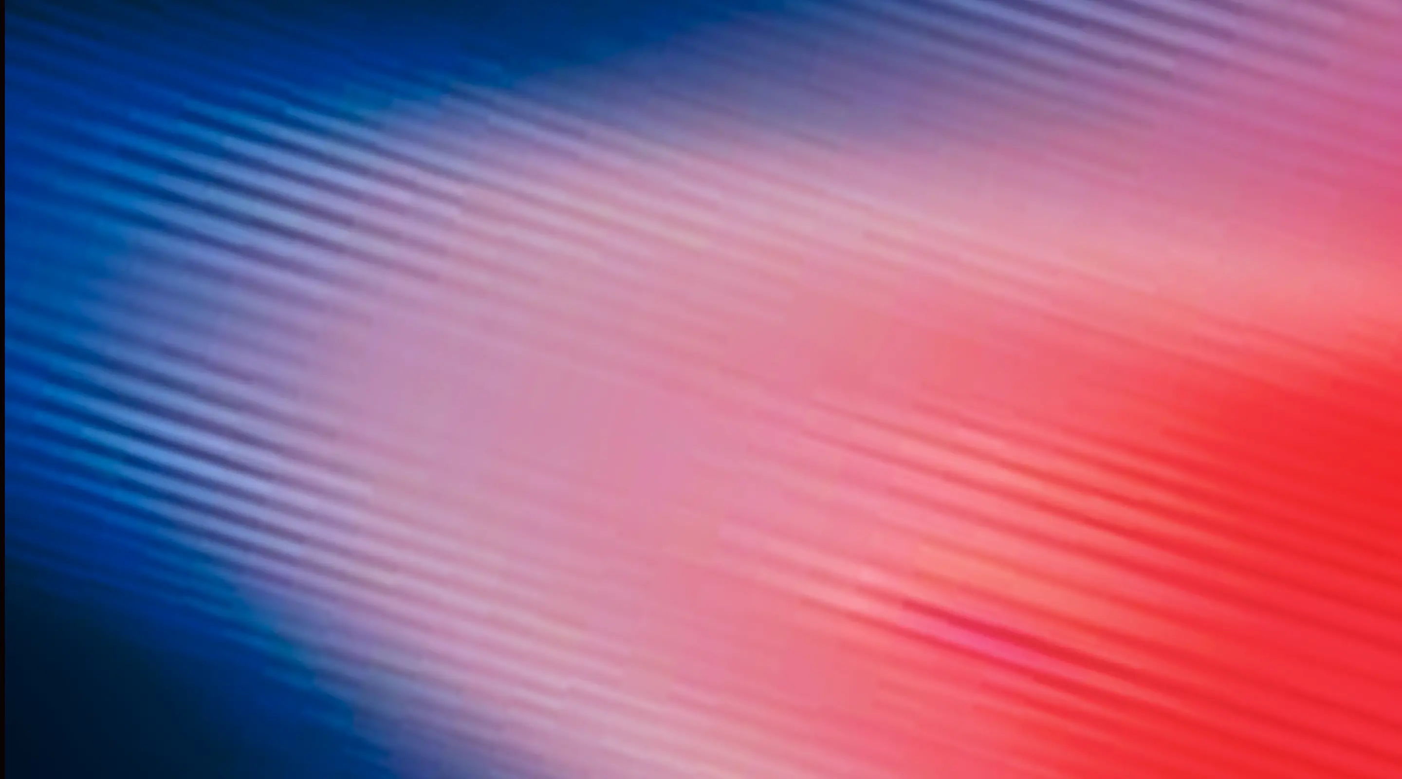 Abstract gradient background with blue and red hues.
