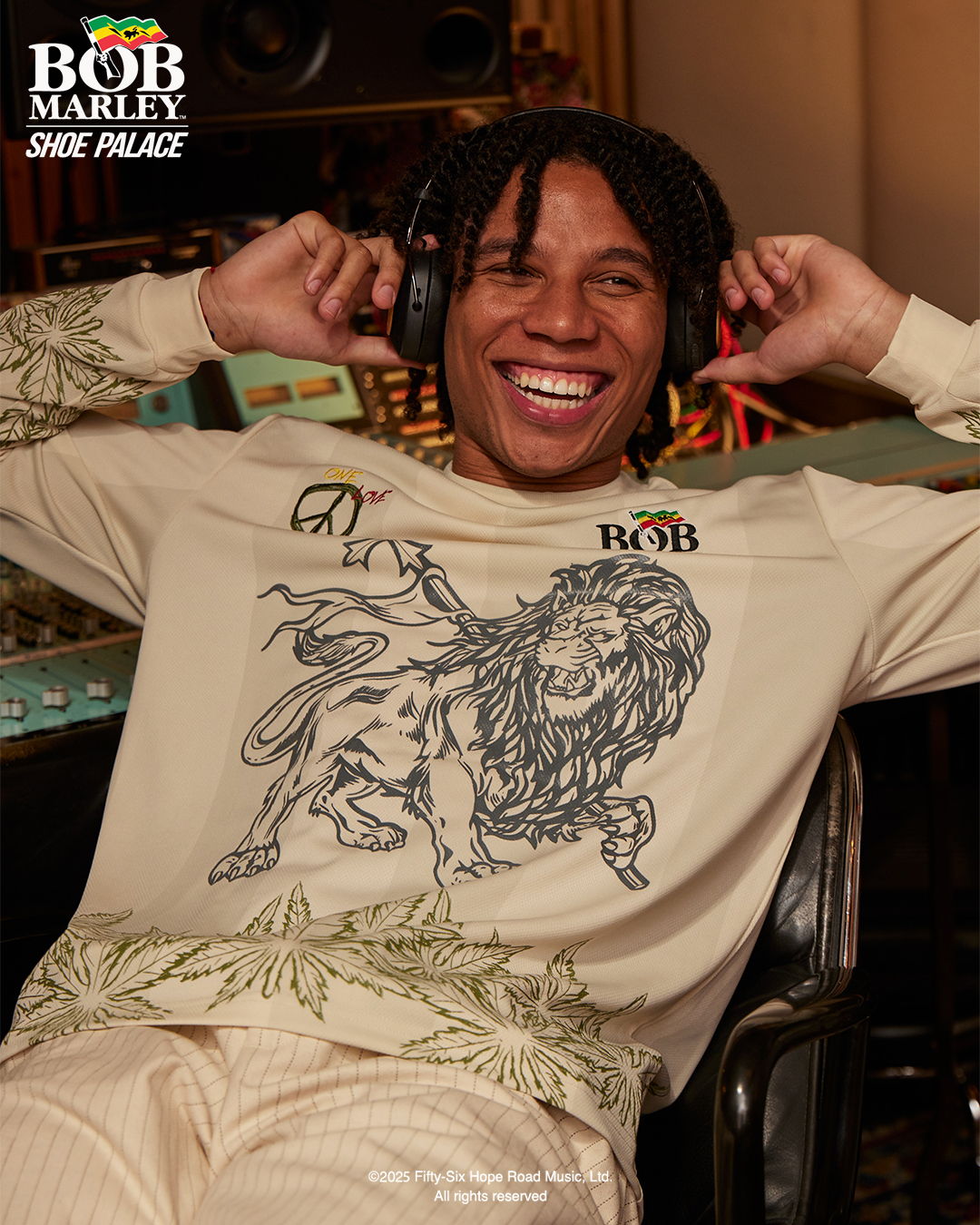 Person smiling while wearing headphones, featuring Bob Marley-themed apparel.