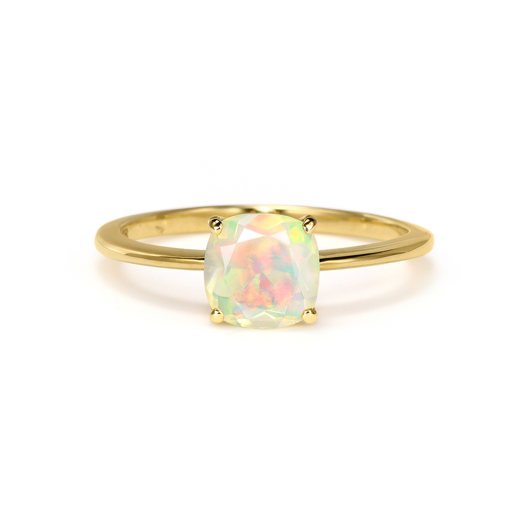 Gold ring with an opal gemstone in a simple setting.