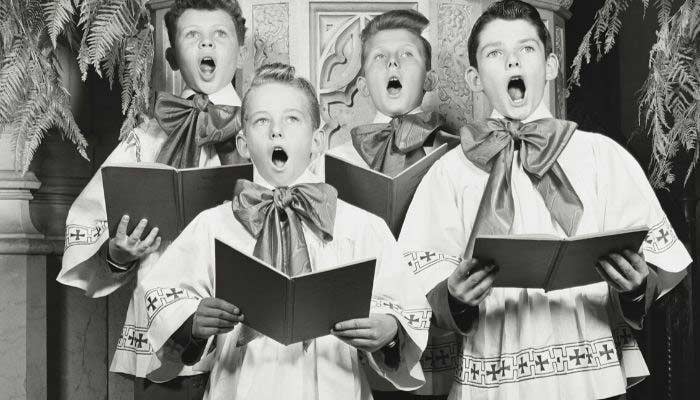 Vintage photo of choir boys singing wearing oversized bow ties