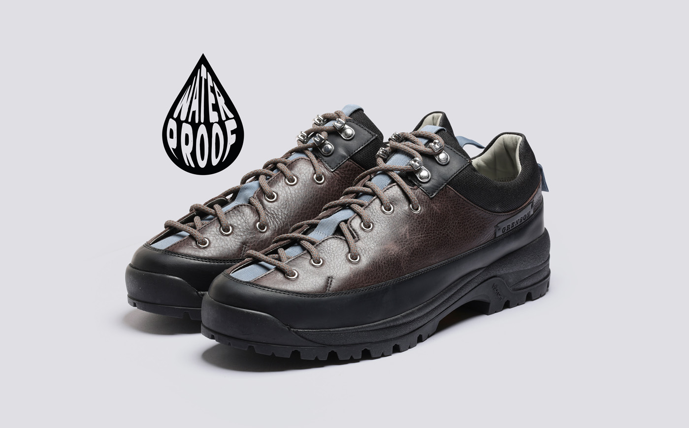 Sneaker 70 - Brown waterproof hiking shoes on a light gray background with logo.