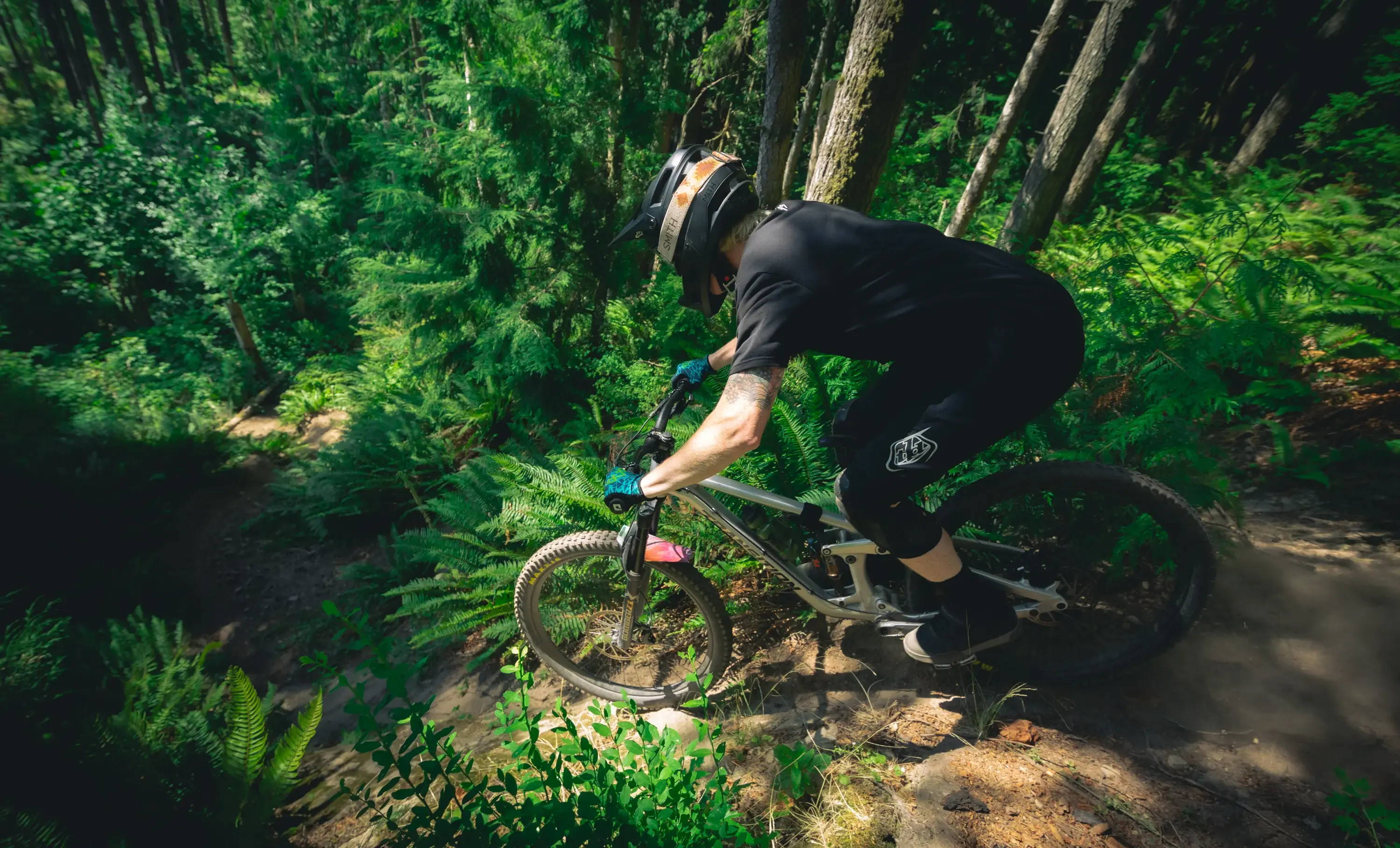 Riding steep MTB trail in PNW forest