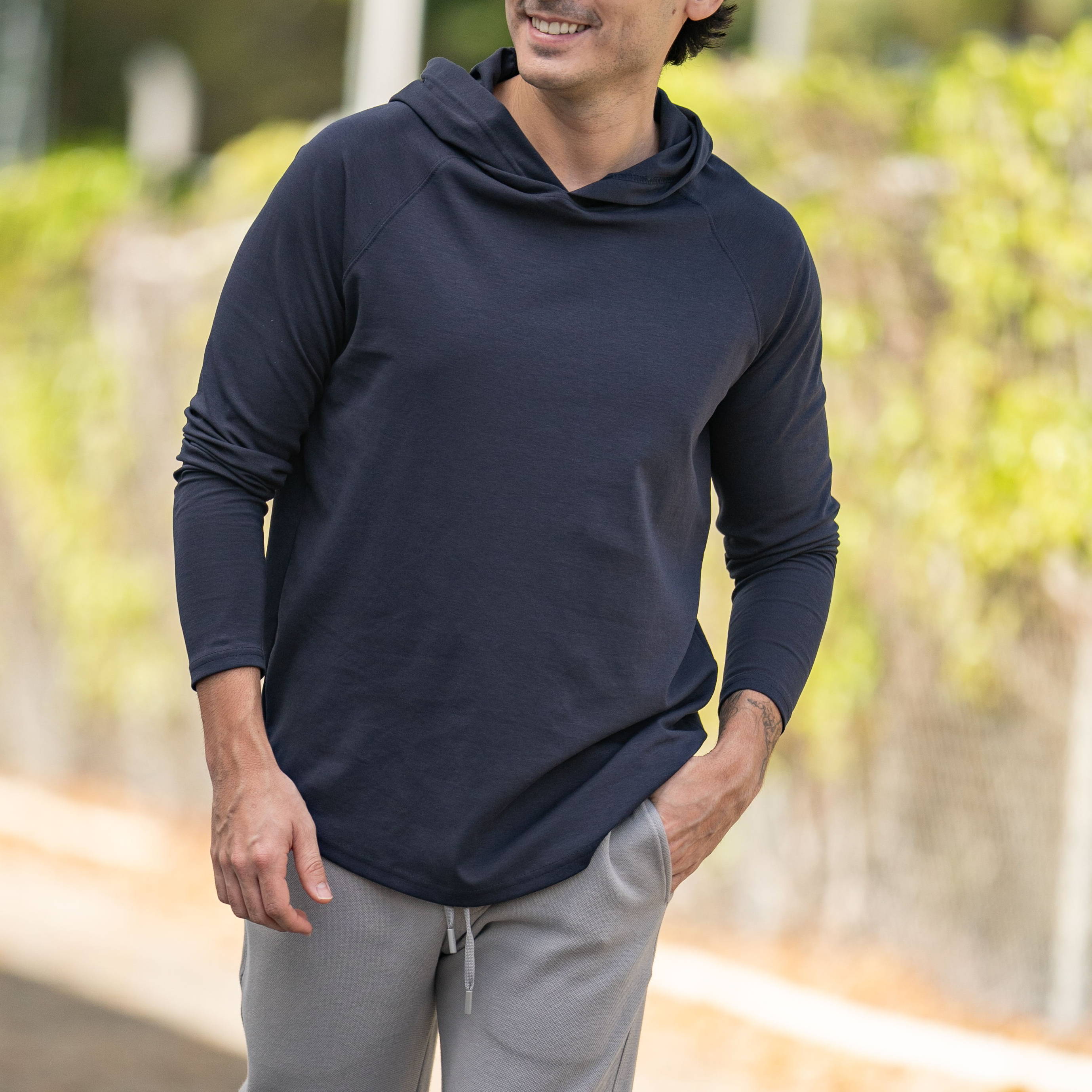 A young man in casual attire walking outdoors.