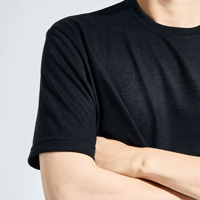 Person in a black t-shirt with arms crossed.
