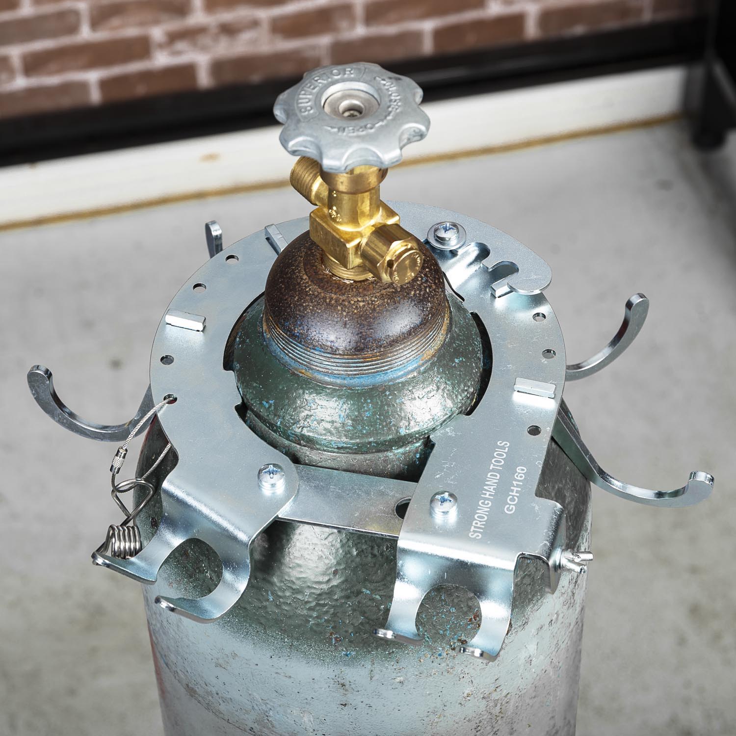 Gas cylinder with a valve and metal securing brackets.