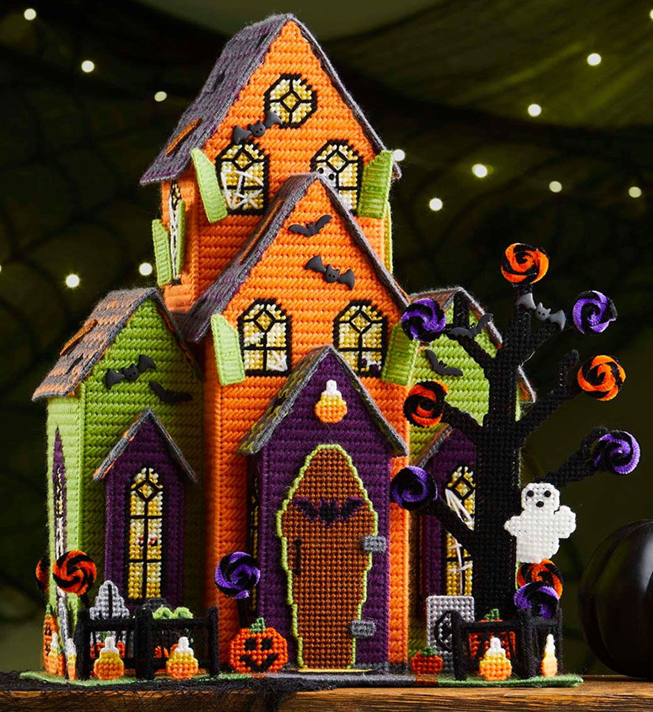 Halloween plastic canvas grand design house with decorations and spooky elements.