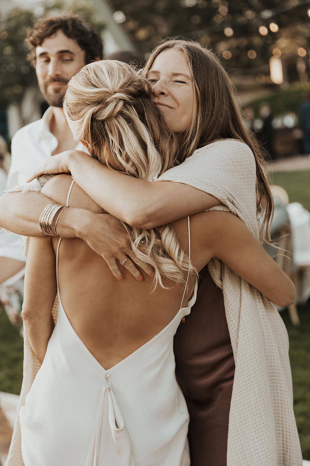Bride hugging wedding guests