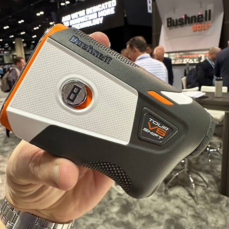 A hand holding the new Bushnell Tour V6 Shift at the PGA Show in 2023