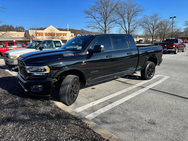 Black RAM 2500 Heavy Duty pickup truck parked in Home Depot parking lot on clear sunny day