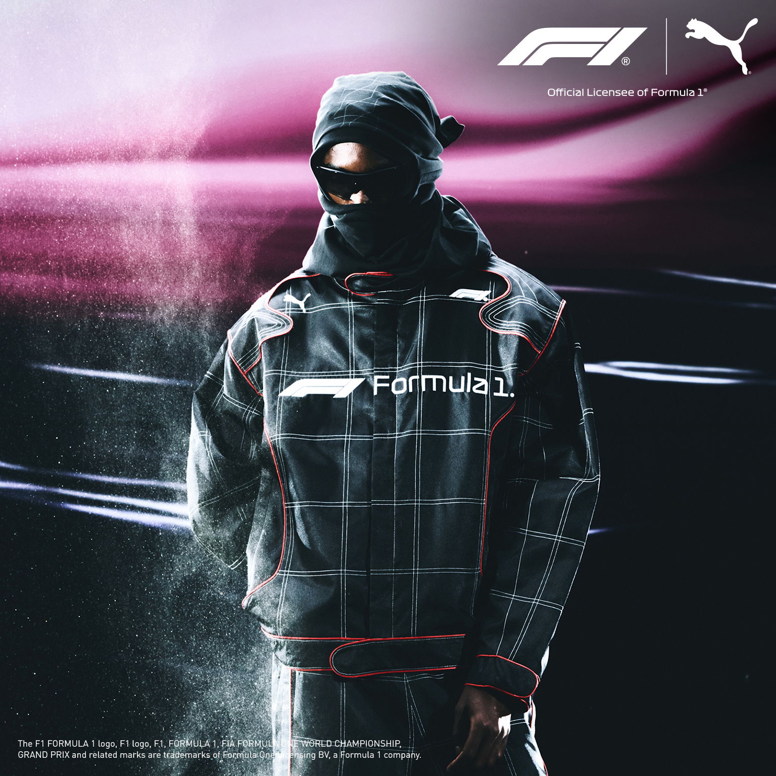PUMA FORMULA 1 - A person wearing a Formula 1 jacket in a dark, smoky environment.