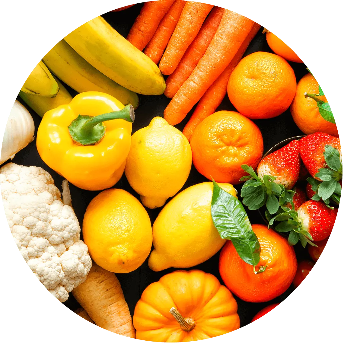 orange and yellow fruits and vegetables arranged on a surface.