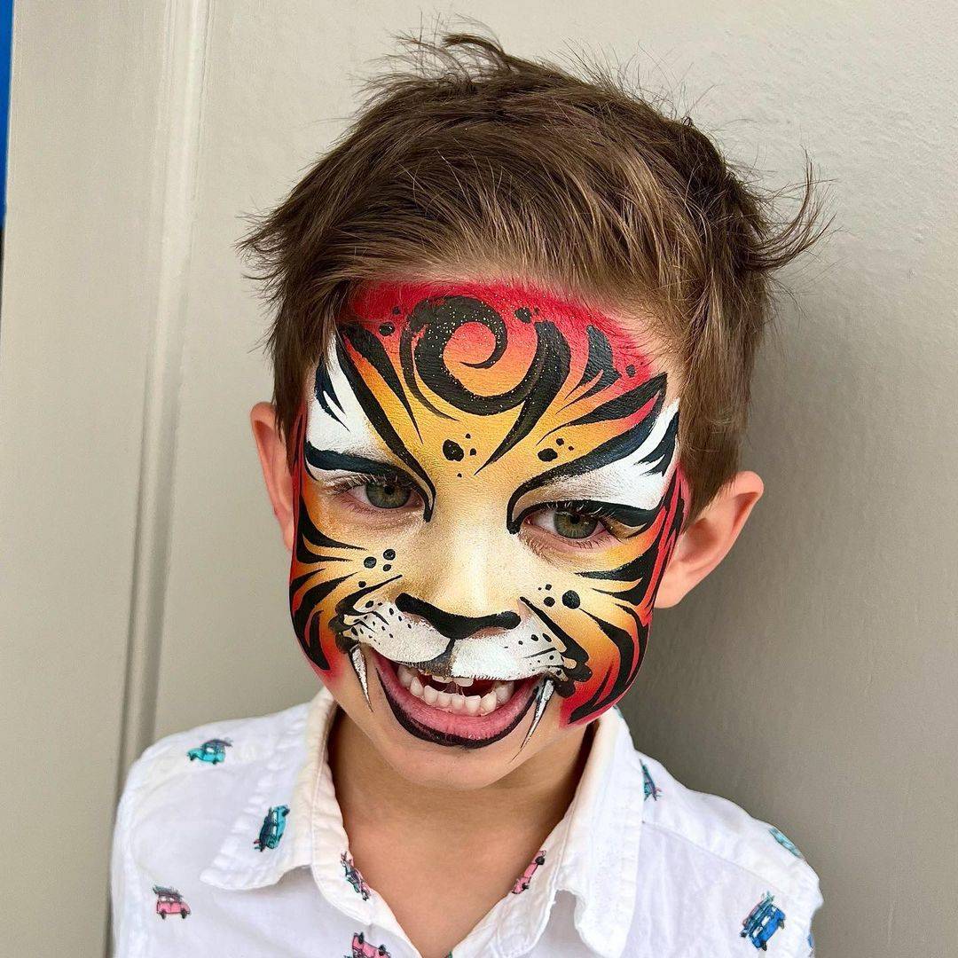 cute orange tiger face paint boy
