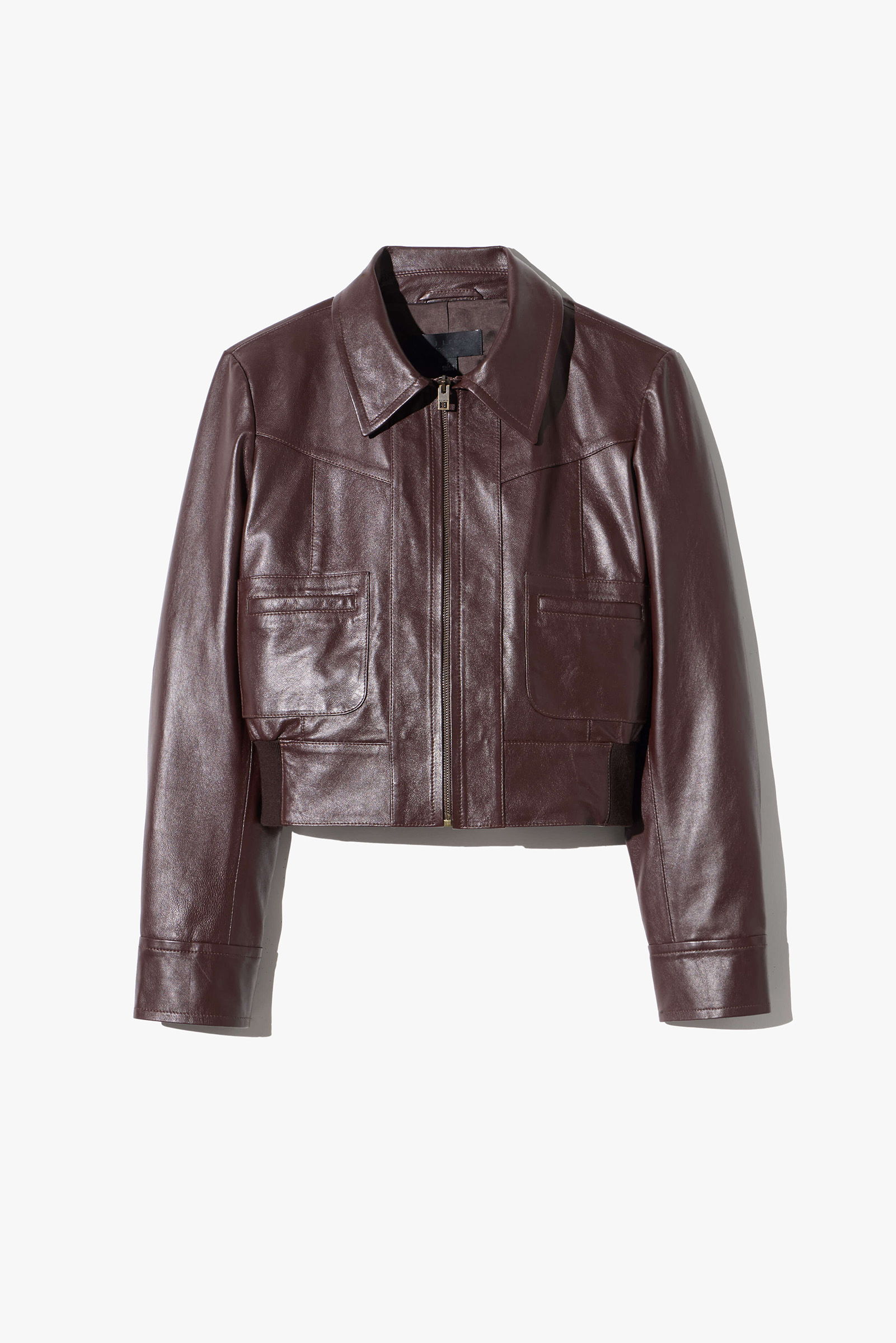Cropped burgundy leather jacket with a collared neckline and front pockets.