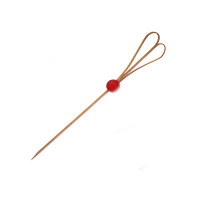 A bamboo skewer with a looped heart design and a red bead