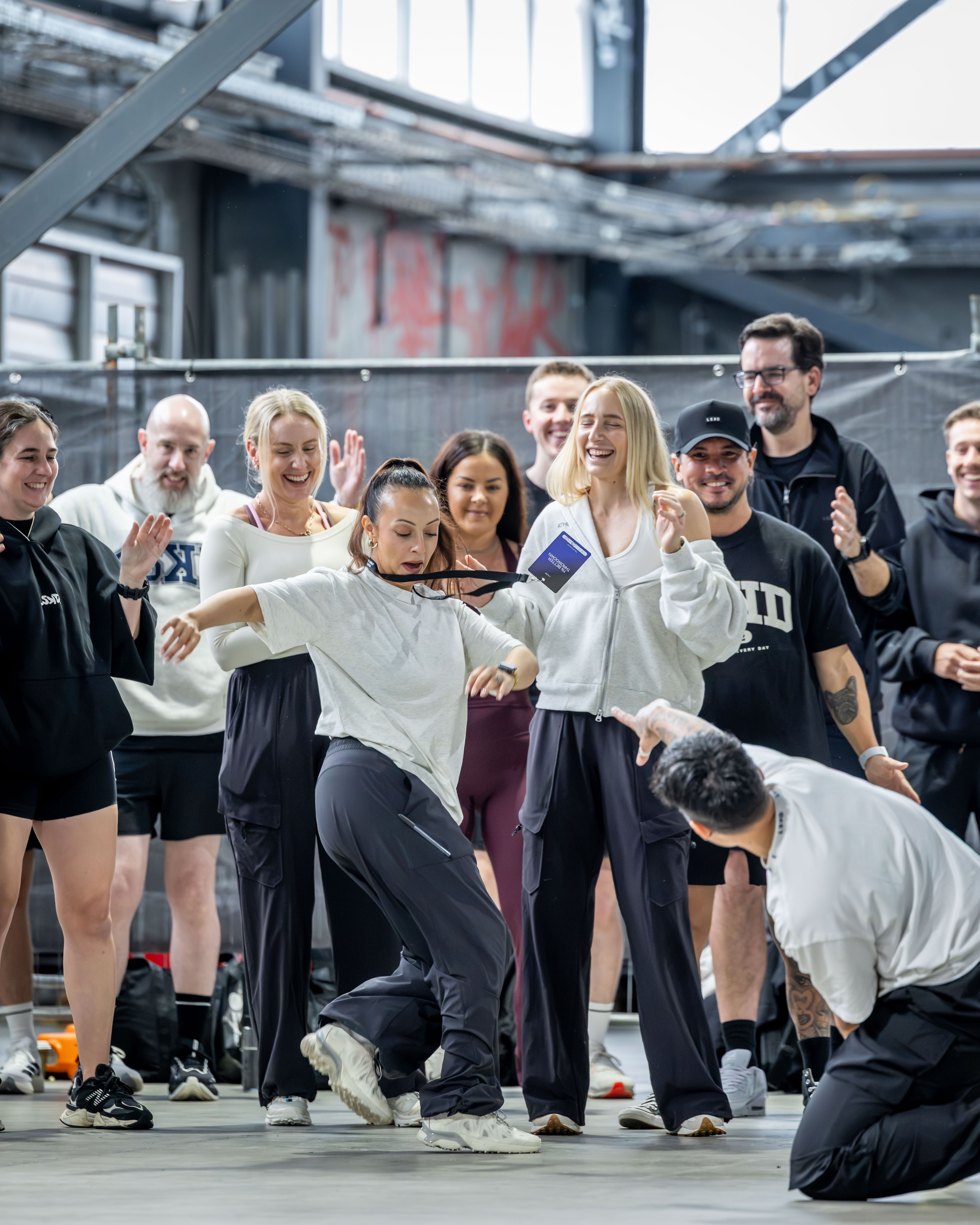 A group of people posing and celebrating in an indoor space.